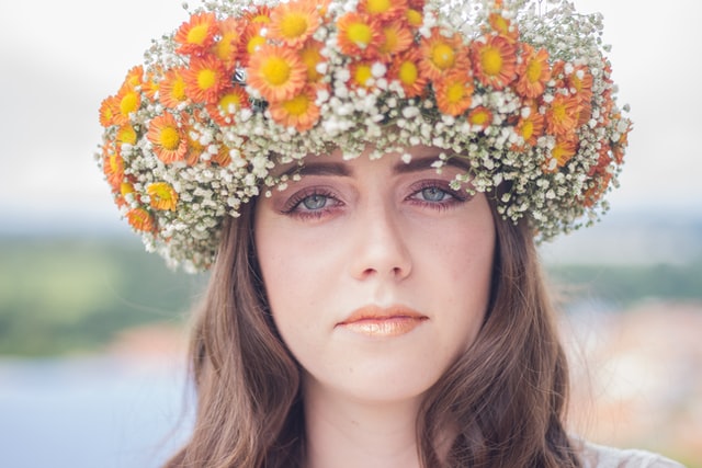 blue eyes woman with orange flower crown