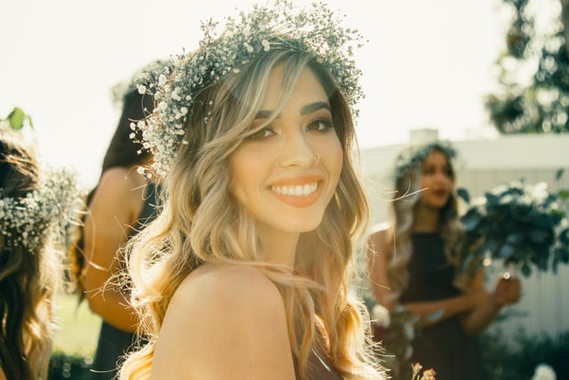 happy woman with white flower crowns with smile